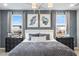 Beautifully staged main bedroom with a king-size bed, stylish lighting, and window views at 312 Providence Creek Dr, Fuquay Varina, NC 27526