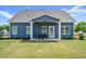 Backyard featuring a dark blue home with covered patio and an outdoor table with chairs at 34 E American Marigold Dr # 64, Benson, NC 27504