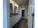 Bathroom featuring double vanity with granite counters, wood-look floor, and linen closet at 34 E American Marigold Dr # 64, Benson, NC 27504