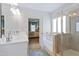 Bathroom with double vanity, soaking tub, glass shower and doorway to bedroom at 34 E American Marigold Dr # 64, Benson, NC 27504