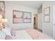 Cozy bedroom with neutral tones, wall art, and a glimpse into the laundry area at 34 E American Marigold Dr # 64, Benson, NC 27504