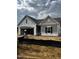 New construction home showcasing stylish gray siding and an attached two-car garage at 34 E American Marigold Dr # 64, Benson, NC 27504