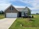 Charming single-story home showcasing a brick and siding exterior with well-manicured lawn at 34 E American Marigold Dr # 64, Benson, NC 27504