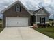 Charming single-story home featuring a two-car garage, brick and siding accents, and a well-manicured front yard at 34 E American Marigold Dr # 64, Benson, NC 27504