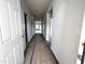 Bright hallway featuring white doors, neutral walls, and a glimpse of the living space at 34 E American Marigold Dr # 64, Benson, NC 27504