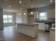 Modern kitchen with granite countertops, stainless steel appliances, and a spacious island at 34 E American Marigold Dr # 64, Benson, NC 27504