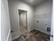 Laundry room with wood look flooring and wire shelving at 34 E American Marigold Dr # 64, Benson, NC 27504
