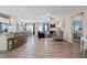 Open-concept living room with wood-look floors, a fireplace, and ample natural light at 34 E American Marigold Dr # 64, Benson, NC 27504