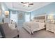 Relaxing main bedroom with a tray ceiling, neutral decor, and comfortable seating area at 34 E American Marigold Dr # 64, Benson, NC 27504