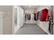 Spacious walk-in closet with wire shelving and plush carpet, leading to the bathroom at 34 E American Marigold Dr # 64, Benson, NC 27504