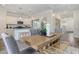 Bright dining area adjacent to a modern kitchen and featuring a wooden table with gray chairs at 39 Atherton Circle, Angier, NC 27501