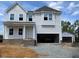 Charming two-story home with a welcoming front porch and an attached two car garage at 39 Atherton Circle, Angier, NC 27501
