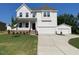 Beautiful two-story home with a two-car garage and landscaped front yard at 39 Atherton Circle, Angier, NC 27501