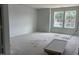 Living room features neutral walls, and windows overlooking backyard at 39 Atherton Circle, Angier, NC 27501