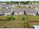 Aerial view of a well-maintained backyard with a patio, lush lawn, and decorative plantings. Fenced for privacy, it's perfect for outdoor living at 4102 Catfish Way, Durham, NC 27703