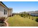 An expansive backyard with lush lawn, landscaping, and a patio area at 4102 Catfish Way, Durham, NC 27703