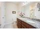 Bathroom featuring double sinks, granite countertops, and tile flooring, exuding elegance and functionality at 4102 Catfish Way, Durham, NC 27703