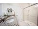 Bathroom with double sinks, granite countertop, tile floors, and a glass enclosed walk-in shower at 4102 Catfish Way, Durham, NC 27703