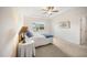 Serene bedroom featuring a tray ceiling, ceiling fan, carpet floors, and natural light from the window at 4102 Catfish Way, Durham, NC 27703