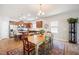 Open floor plan showcasing kitchen with island seating and a dining area with rustic wood table and colorful rug at 4102 Catfish Way, Durham, NC 27703