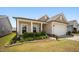 Charming home featuring stone accents, manicured landscaping, and a welcoming front porch for relaxing in a quiet neighborhood at 4102 Catfish Way, Durham, NC 27703