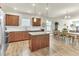 Open-concept kitchen with a center island with wooden cabinets and open view to the dining room at 4102 Catfish Way, Durham, NC 27703