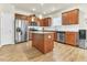 Modern kitchen with stainless steel appliances, granite countertops, and center island with wooden cabinets at 4102 Catfish Way, Durham, NC 27703