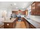 Bright kitchen with stainless steel appliances, granite countertops, white subway tile backsplash, and wood cabinets at 4102 Catfish Way, Durham, NC 27703