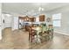 Bright open-concept kitchen and dining area with stainless steel appliances and wooden table with seating at 4102 Catfish Way, Durham, NC 27703