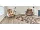 Relaxing living room with stylish floral accent chair, leather recliner and a decorative area rug at 4102 Catfish Way, Durham, NC 27703