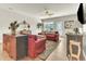 Cozy living room with couches, area rug, and natural lighting from the open doorway and windows at 4102 Catfish Way, Durham, NC 27703