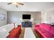 Inviting living room with a media center, ceiling fan, comfortable sofas, and ample lighting for relaxation and entertainment at 4102 Catfish Way, Durham, NC 27703