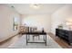 Open office area with sleek desk, accent chair, and wood flooring at 4102 Catfish Way, Durham, NC 27703