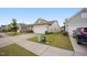 Suburban home with a two car garage, light siding, landscaping and a concrete driveway in a quiet residential neighborhood at 4102 Catfish Way, Durham, NC 27703