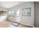 Bright sunroom with large window, door to the backyard, indoor plants, light gray walls, and wood flooring at 4102 Catfish Way, Durham, NC 27703