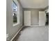 This bedroom features gray walls, carpet floors, a window, and white doors at 414 Longfellow St, Fuquay Varina, NC 27526