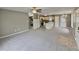 Expansive living room open to kitchen with neutral tones and carpet throughout at 414 Longfellow St, Fuquay Varina, NC 27526