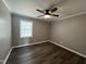 Bedroom features a ceiling fan, hardwood floors, and natural light from a window at 427 Elm Ct, Burlington, NC 27215