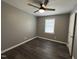 Comfortable bedroom featuring updated flooring, neutral walls, and ceiling fan at 427 Elm Ct, Burlington, NC 27215