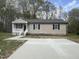 Charming home with a small porch, sidewalk, and large driveway at 427 Elm Ct, Burlington, NC 27215