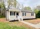 Charming single-story home with a welcoming front porch and freshly landscaped yard at 427 Elm Ct, Burlington, NC 27215
