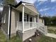 Inviting front entrance with a cozy porch and well-maintained landscaping at 427 Elm Ct, Burlington, NC 27215