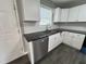 Bright kitchen with stainless appliances, subway tile backsplash, and ample counter space at 427 Elm Ct, Burlington, NC 27215