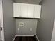 Laundry room featuring storage cabinets, gray walls, and washer/dryer hookups at 427 Elm Ct, Burlington, NC 27215