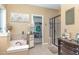Relaxing bathroom featuring a tub with tile surround, glass-enclosed shower, and walk-in closet at 45 Pebble Creek Dr, Franklinton, NC 27525