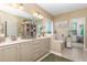 A well-lit bathroom with double sinks, a bathtub, and stylish decor, offering a relaxing space at 45 Pebble Creek Dr, Franklinton, NC 27525