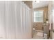 Bright bathroom with a neutral color scheme, shower with curtain, and built-in storage at 45 Pebble Creek Dr, Franklinton, NC 27525