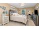 Serene bedroom featuring soft hues, a decorative headboard, and a well-lit workspace by the window at 45 Pebble Creek Dr, Franklinton, NC 27525