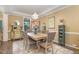 Cozy dining room with a wooden table, upholstered chairs, and elegant decor at 45 Pebble Creek Dr, Franklinton, NC 27525