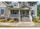 Inviting front porch with stone steps, white railings, and decorative plants leading to the front door at 45 Pebble Creek Dr, Franklinton, NC 27525